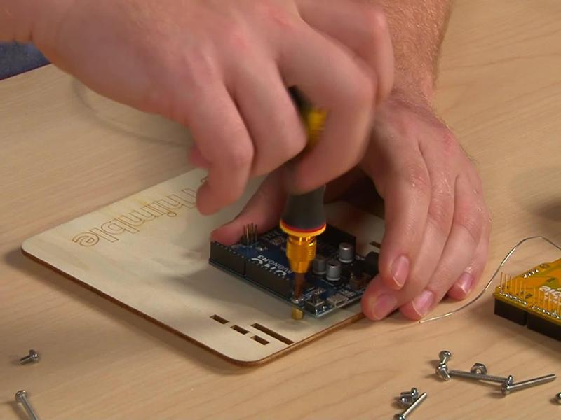 Use a screwdriver and screw to secure the Arduino in place